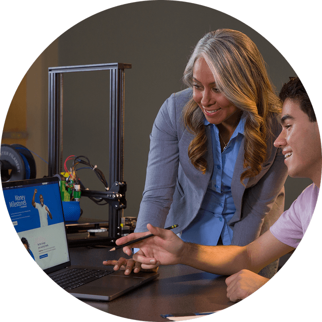 Two people looking at Money Milestones.